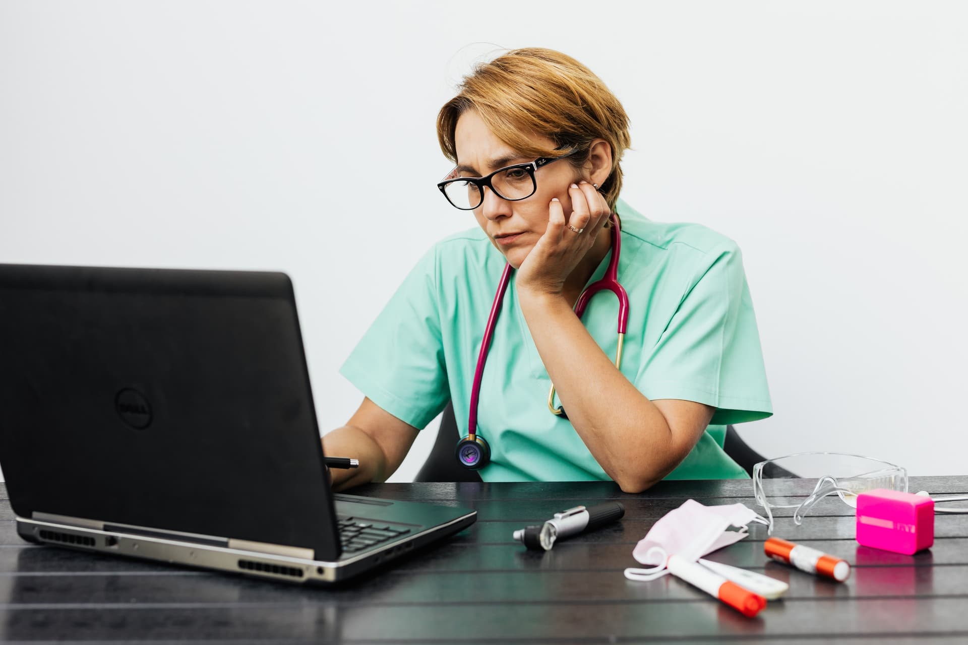An independent care professional sitting at a desk, quietly working through the challenges of building a practice alone